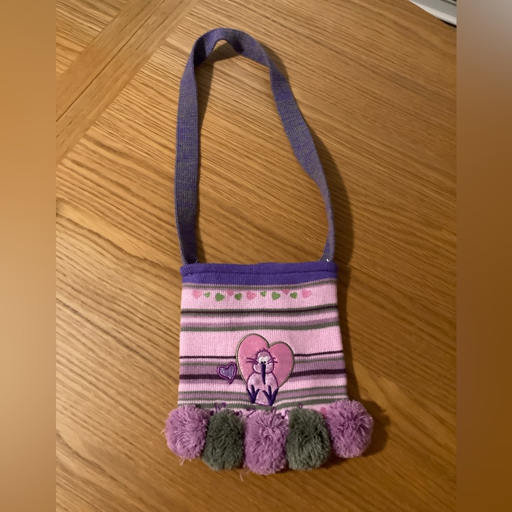 Cute bag with great colors of purple and pink and green. Never used. Like new.